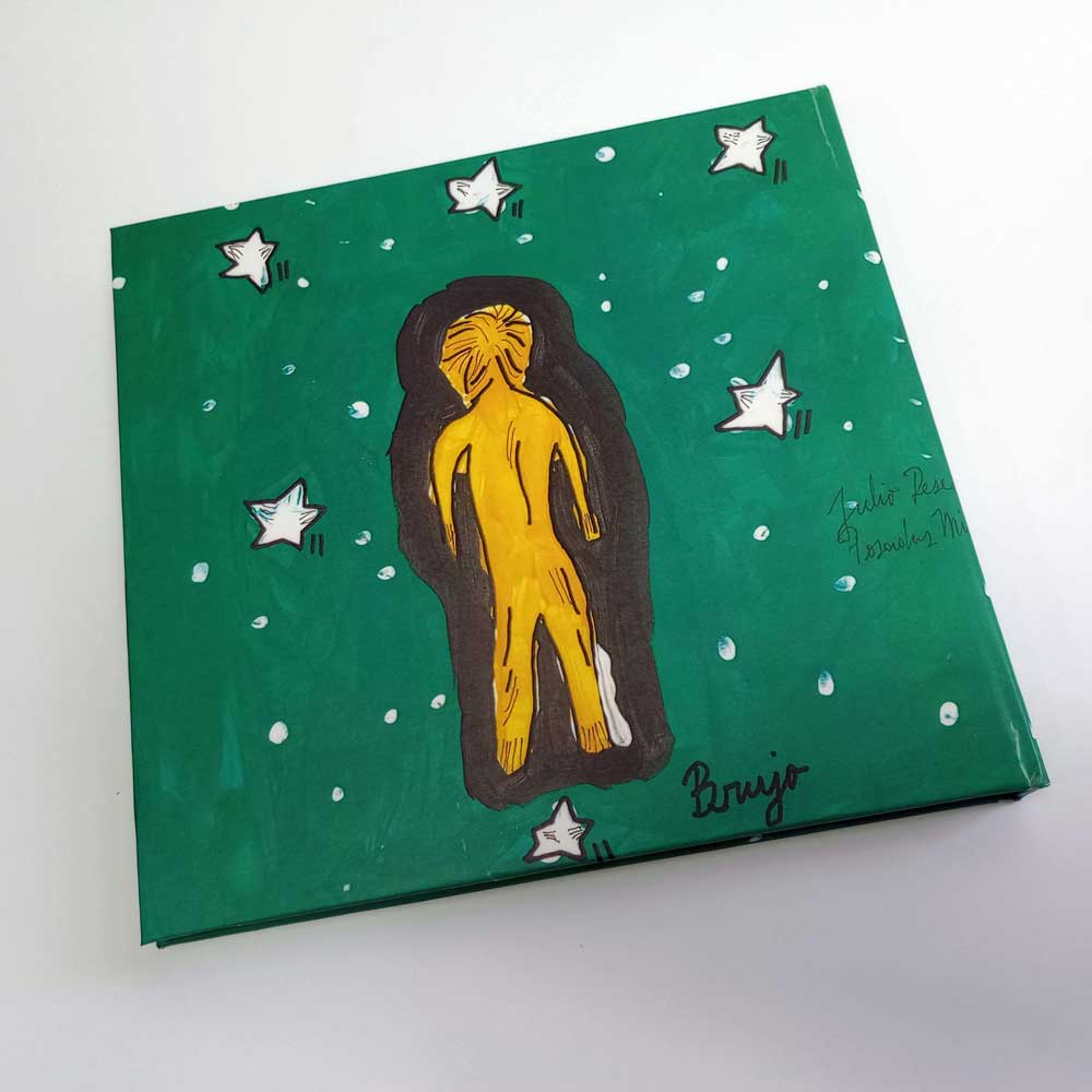 Contratapa del libro El Monte de Julio Resek con ilustración de figura dorada sobre fondo verde con estrellas blancas